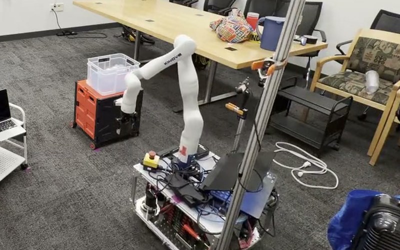 A mobile manipulator clearing objects to navigate through a cluttered room